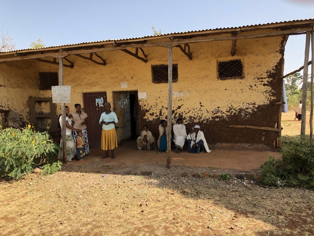 Image of people outside a house